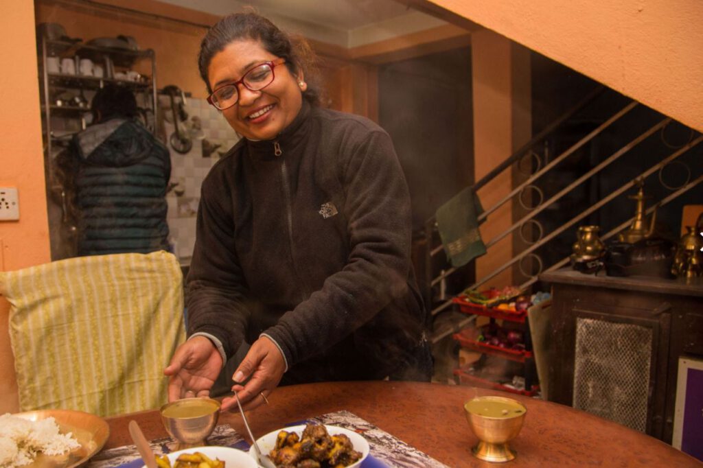 Local woman serving dinner at Panauti Community Homestay