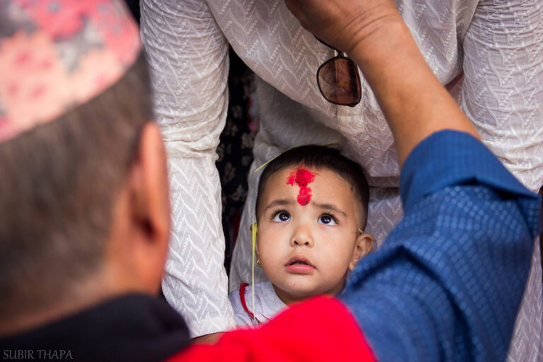 Young boy receiving a tika at Dashain in Nepal